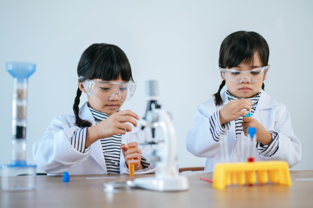 Two girls doing science experiments lab selective focus
